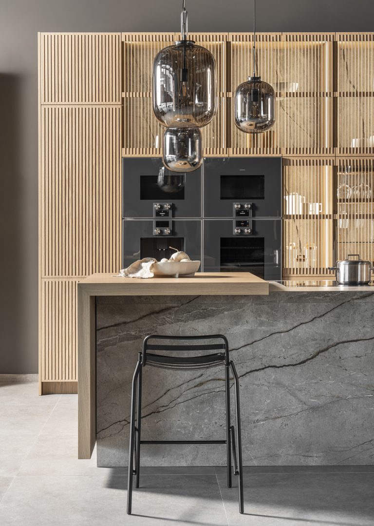 Imperial Oak kitchen collection, inspired by nature, featuring an integrated sintered stone sink, oak island with electric elements, and high cabinetry with built-in appliances.