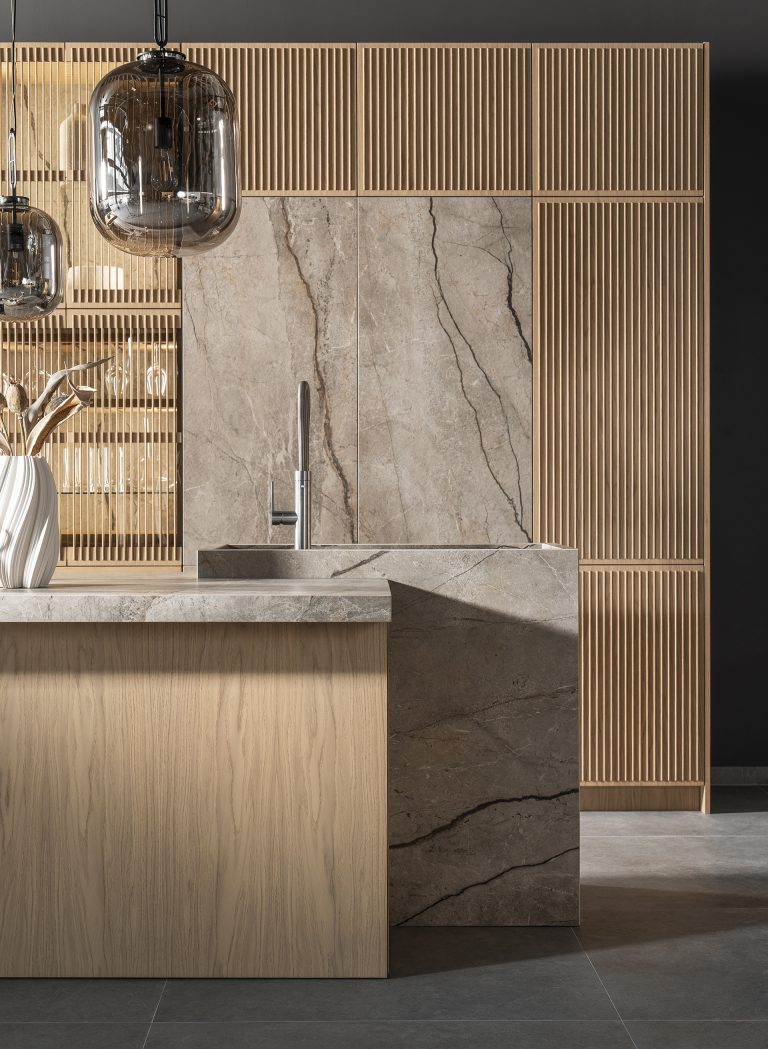 My-Space Imperial Oak kitchen, designed with a seamless sintered stone sink, oak-framed glass niches, and a practical wine storage solution.