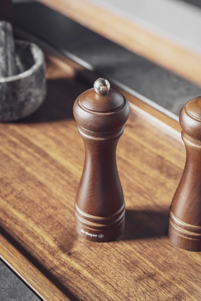 Stylish modern kitchen featuring black fluted fronts and warm oak-lit niches, creating a cozy yet sophisticated ambiance. Part of the Arta Kitchen Collection by MY-SPACE.
