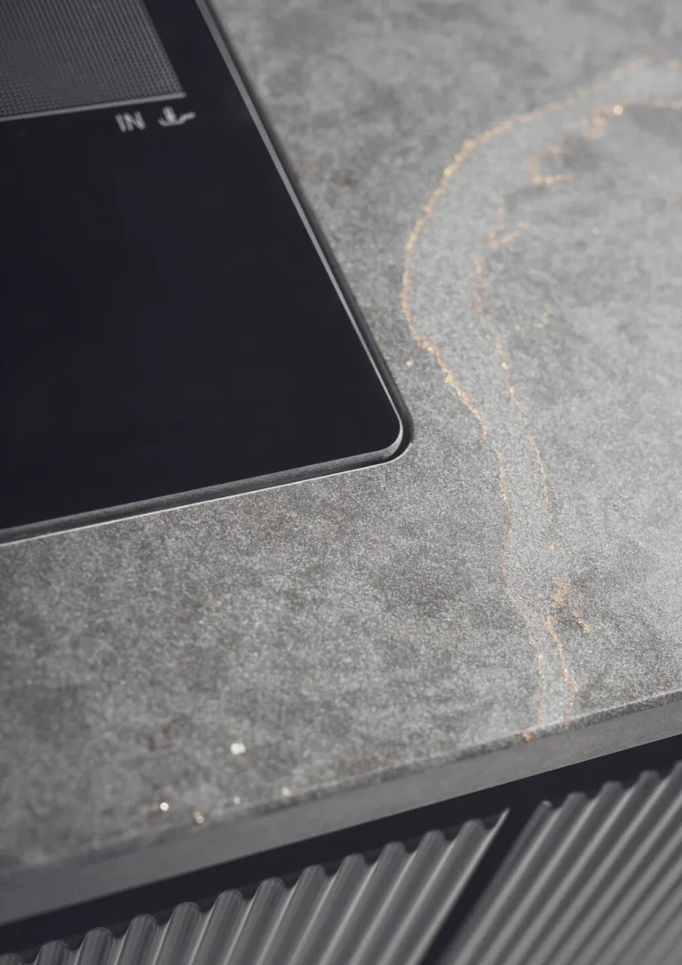 Stylish modern kitchen featuring black fluted fronts and warm oak-lit niches, creating a cozy yet sophisticated ambiance. Part of the Arta Kitchen Collection by MY-SPACE.