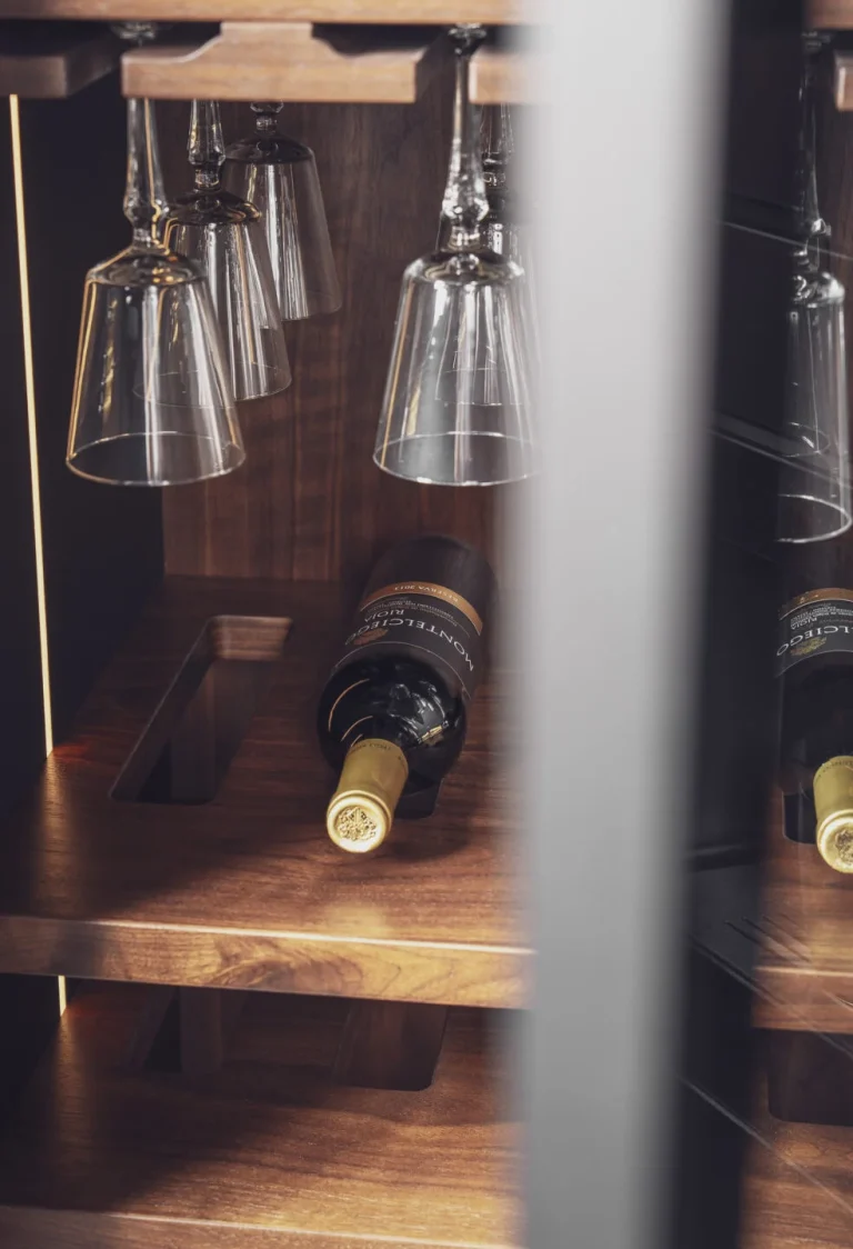 Stylish modern kitchen featuring black fluted fronts and warm oak-lit niches, creating a cozy yet sophisticated ambiance. Part of the Arta Kitchen Collection by MY-SPACE.