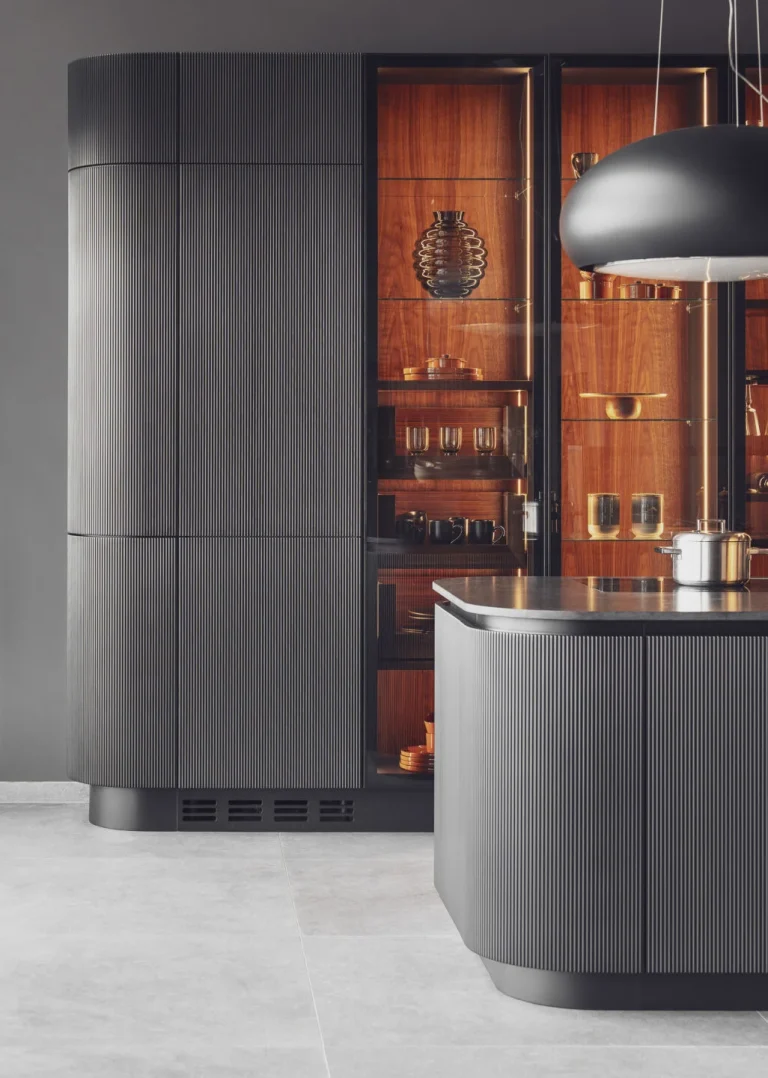 Stylish modern kitchen featuring black fluted fronts and warm oak-lit niches, creating a cozy yet sophisticated ambiance. Part of the Arta Kitchen Collection by MY-SPACE.