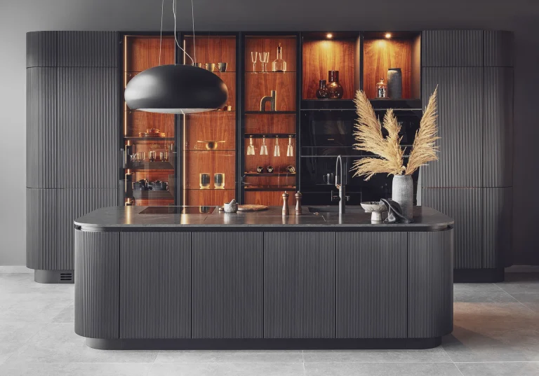 Stylish modern kitchen featuring black fluted fronts and warm oak-lit niches, creating a cozy yet sophisticated ambiance. Part of the Arta Kitchen Collection by MY-SPACE.
