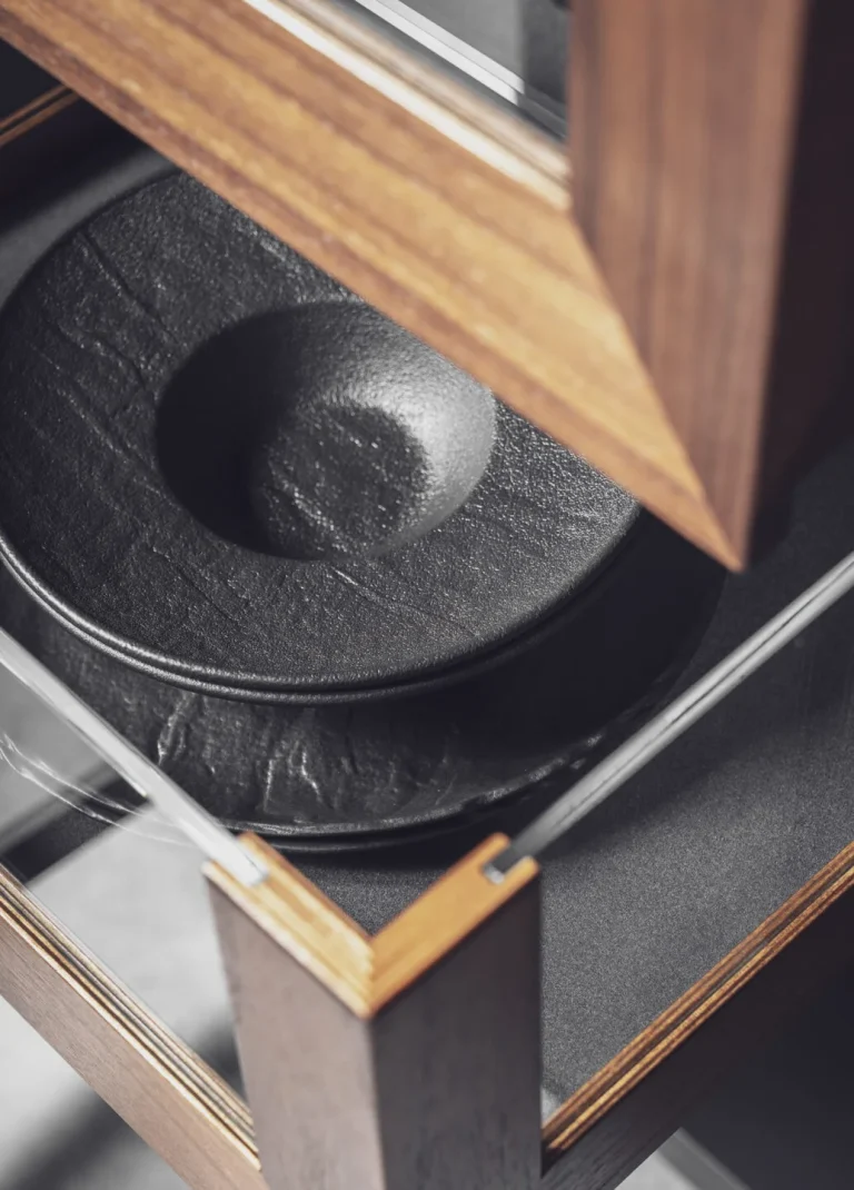 Stylish modern kitchen featuring black fluted fronts and warm oak-lit niches, creating a cozy yet sophisticated ambiance. Part of the Arta Kitchen Collection by MY-SPACE.