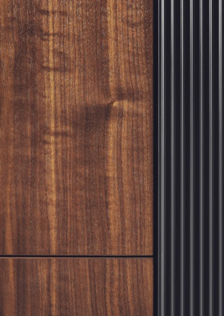 Stylish modern kitchen featuring black fluted fronts and warm oak-lit niches, creating a cozy yet sophisticated ambiance. Part of the Arta Kitchen Collection by MY-SPACE.