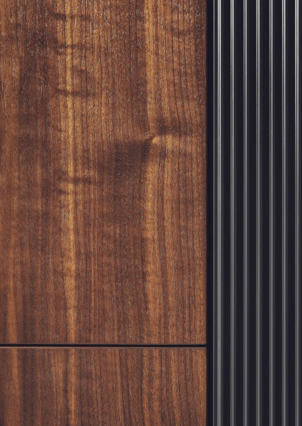 Stylish modern kitchen featuring black fluted fronts and warm oak-lit niches, creating a cozy yet sophisticated ambiance. Part of the Arta Kitchen Collection by MY-SPACE.