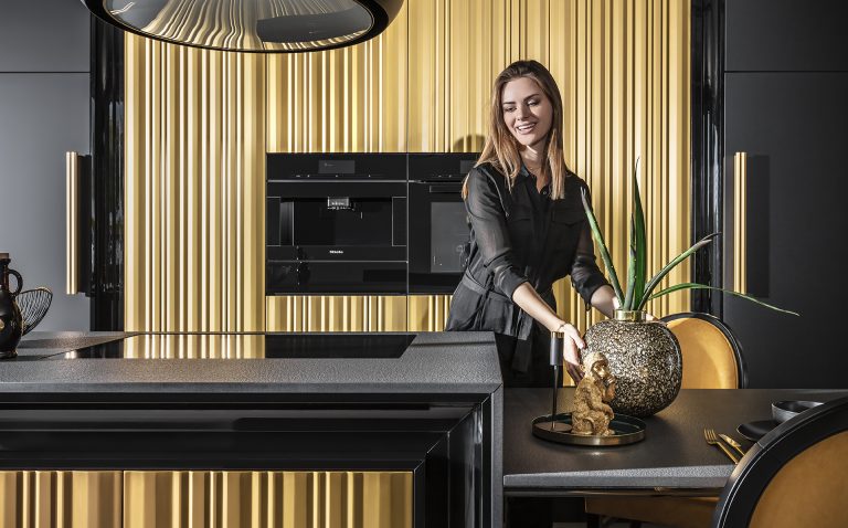 Modern kitchen with luxurious gold wavy fronts from the Ariana Kitchen Collection by MY-SPACE, perfect for a glamorous interior.