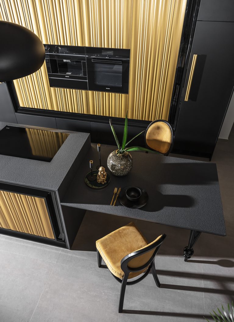Modern kitchen with luxurious gold wavy fronts from the Ariana Kitchen Collection by MY-SPACE, perfect for a glamorous interior.
